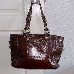 Coach EUC Y2K Shiny Leather Brown Shoulder Bag.  Cross locks on side pockets.
